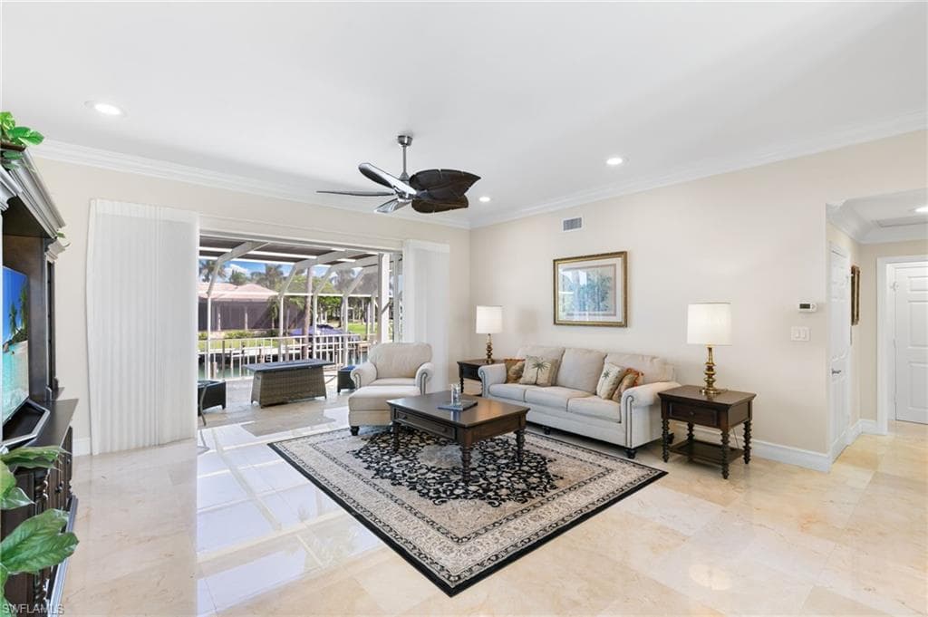 Living area featuring ornamental molding, recessed lighting, a ceiling fan, and a sunroom