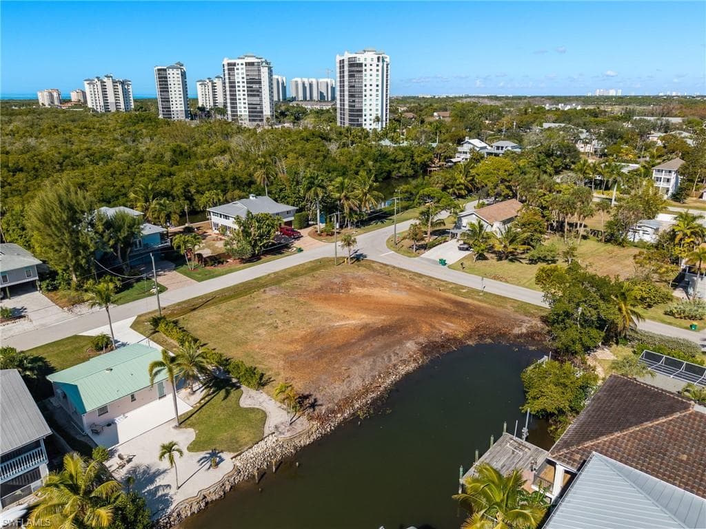 View of urban area with a large body of water and a tree filled landscape