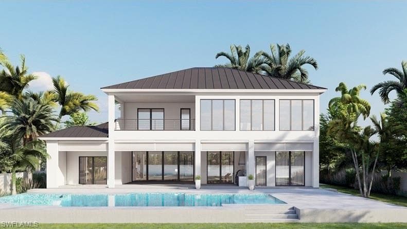 Back of property with a patio area, a balcony, a metal roof, a standing seam roof, and an outdoor pool