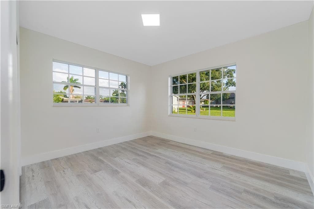 Unfurnished bedroom featuring light wood finished floors and a closet