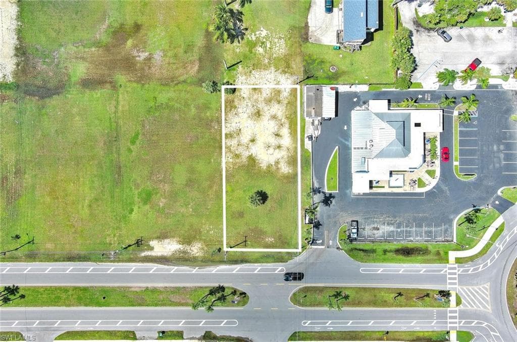 Aerial view of property and surrounding area with property parcel outlined