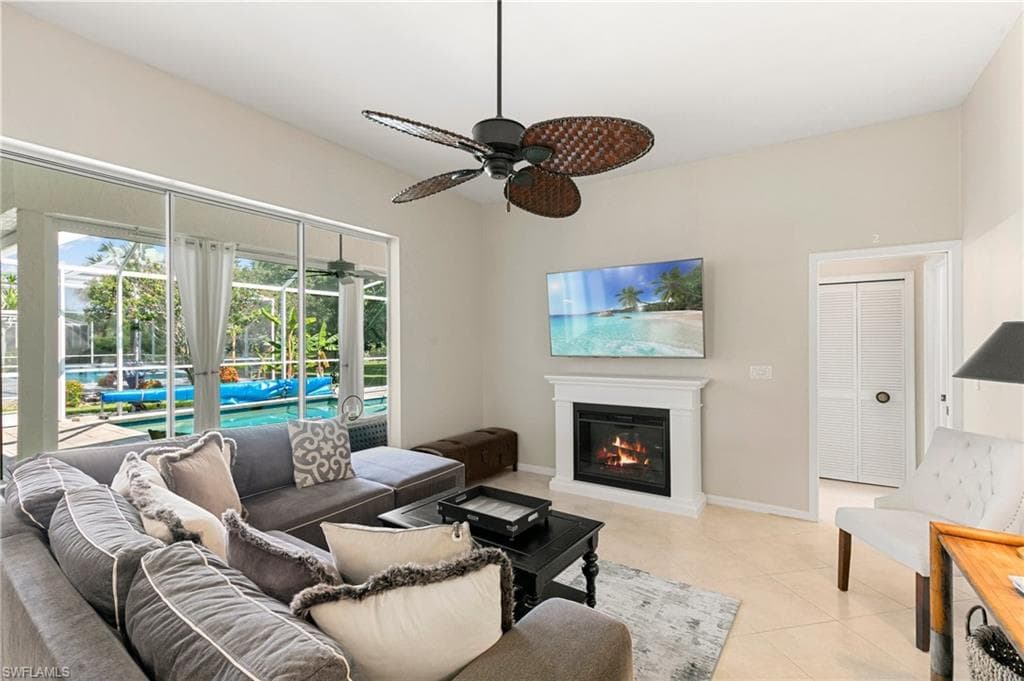 Tiled living room featuring ceiling fan
