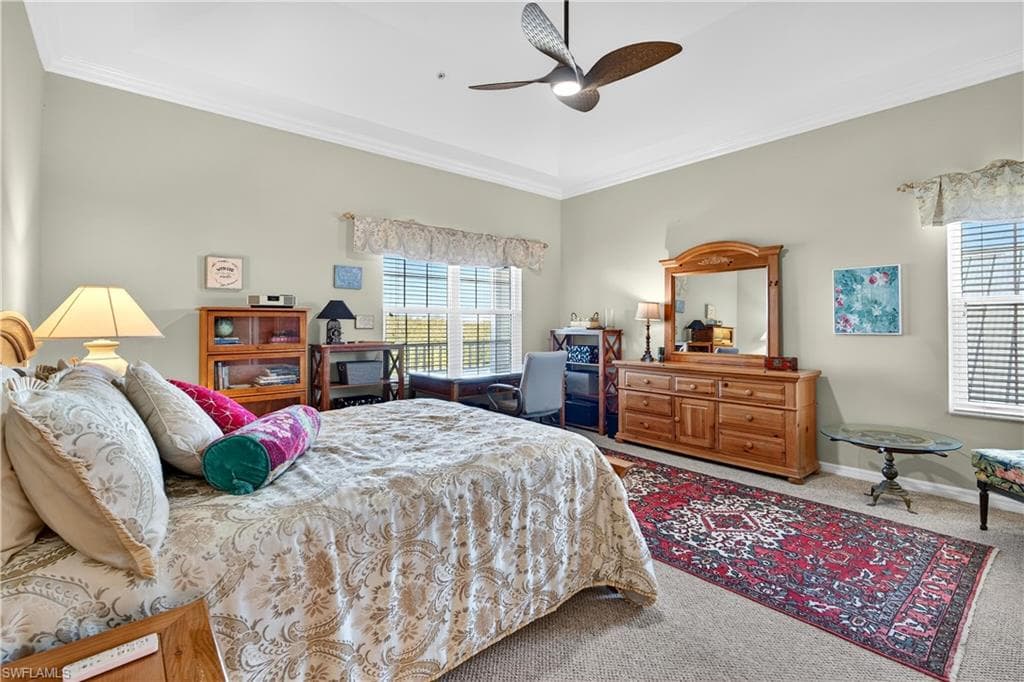 Bedroom with carpet, crown molding, and ceiling fan