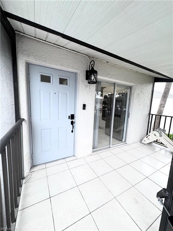 Entrance to property with stucco siding