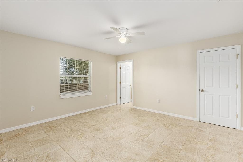 Unfurnished bedroom featuring ceiling fan and baseboards