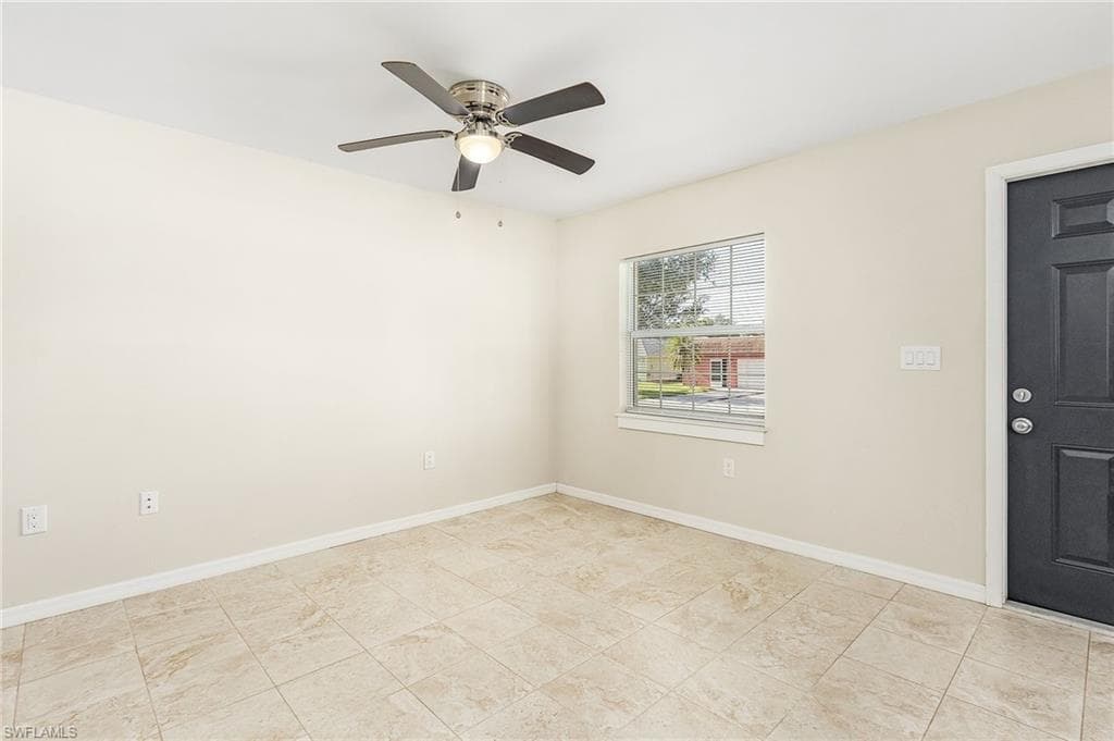 Unfurnished room featuring baseboards and a ceiling fan