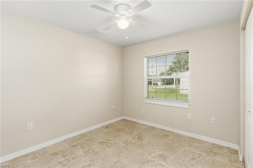 Unfurnished room with baseboards and ceiling fan