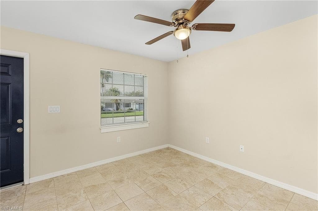Spare room with baseboards and ceiling fan