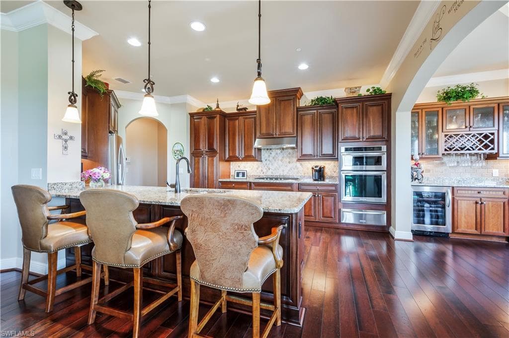 Open kitchen with bar stool seating.