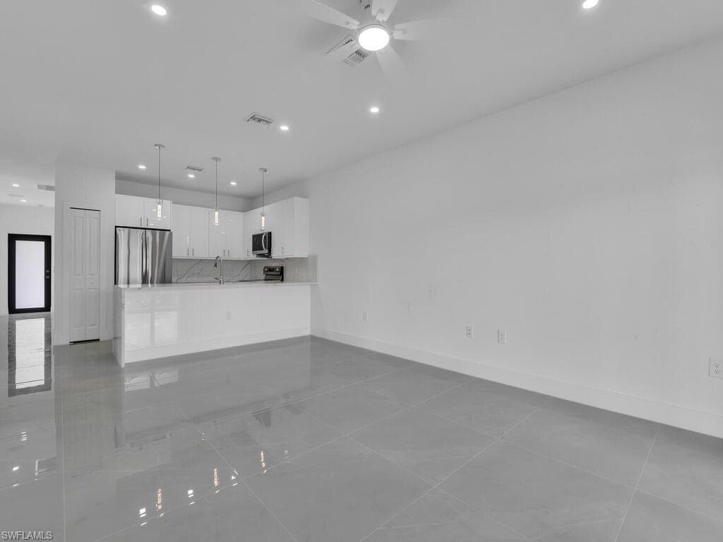 Unfurnished living room featuring recessed lighting, light tile patterned flooring, and a ceiling fan