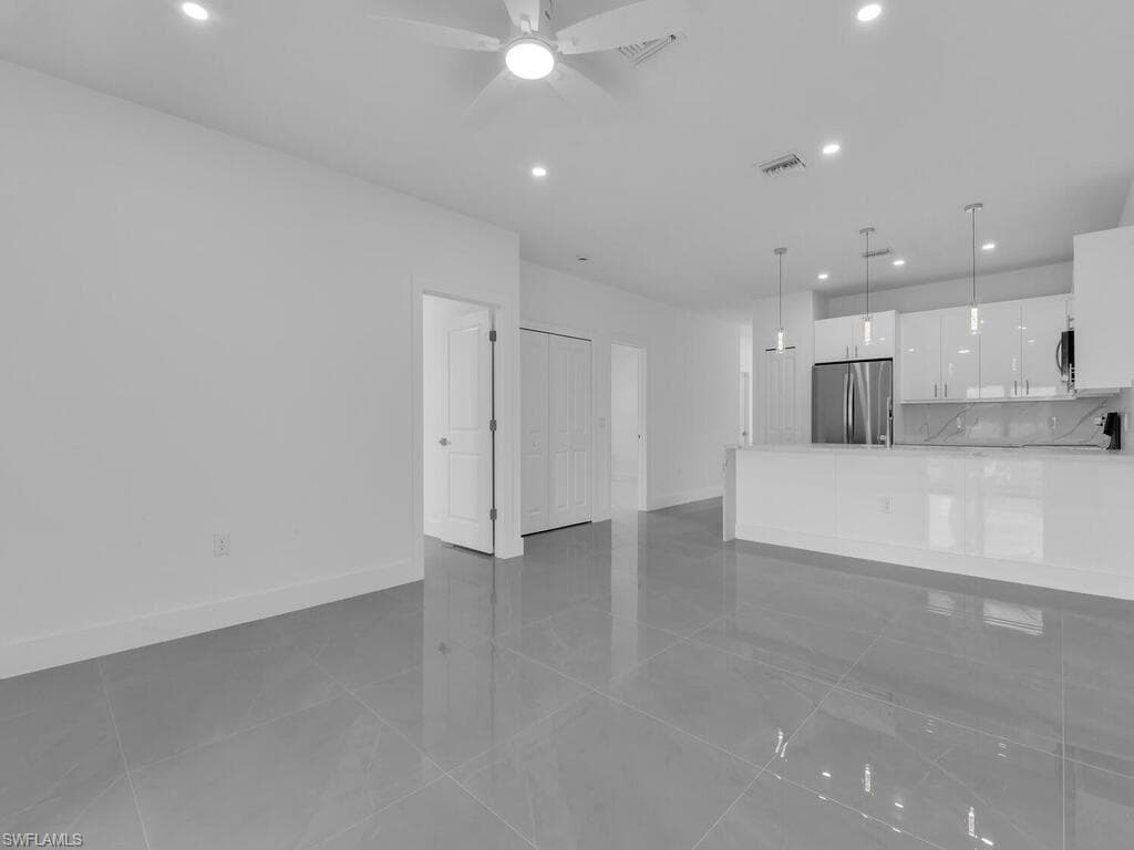 Unfurnished living room featuring recessed lighting, light tile patterned floors, and ceiling fan