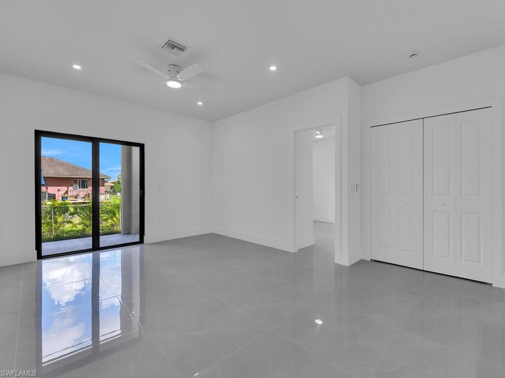 Unfurnished bedroom featuring recessed lighting, light tile patterned floors, ceiling fan, and a closet