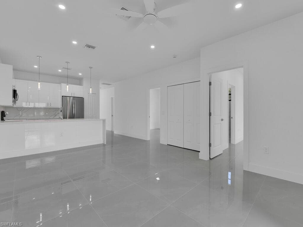 Unfurnished living room featuring recessed lighting, light tile patterned flooring, and ceiling fan