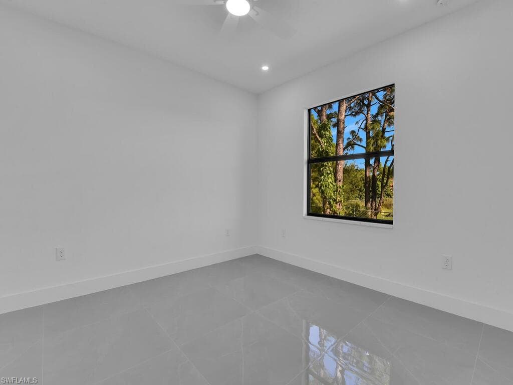 Tiled spare room featuring recessed lighting and ceiling fan