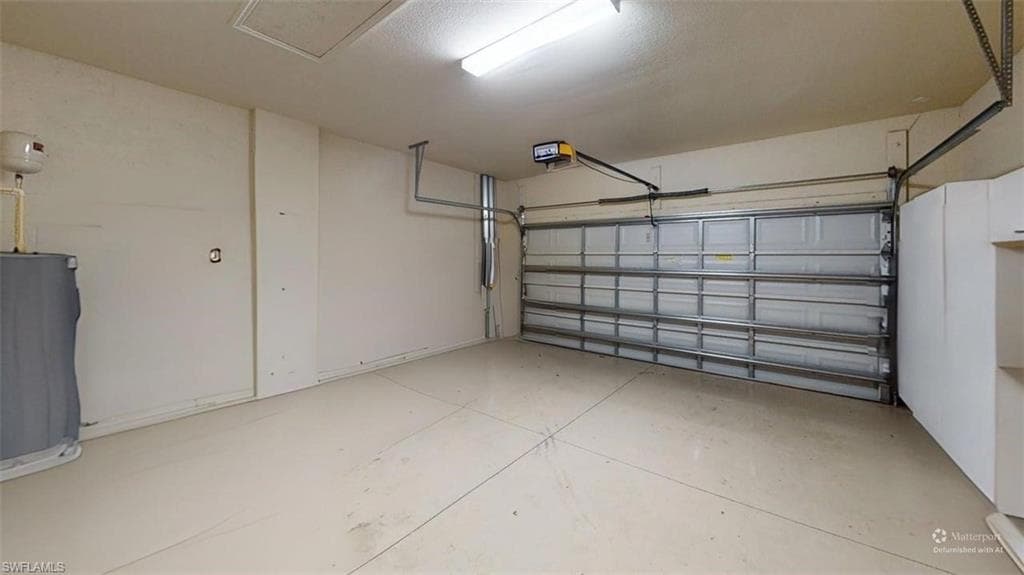 Garage featuring water heater and a garage door opener