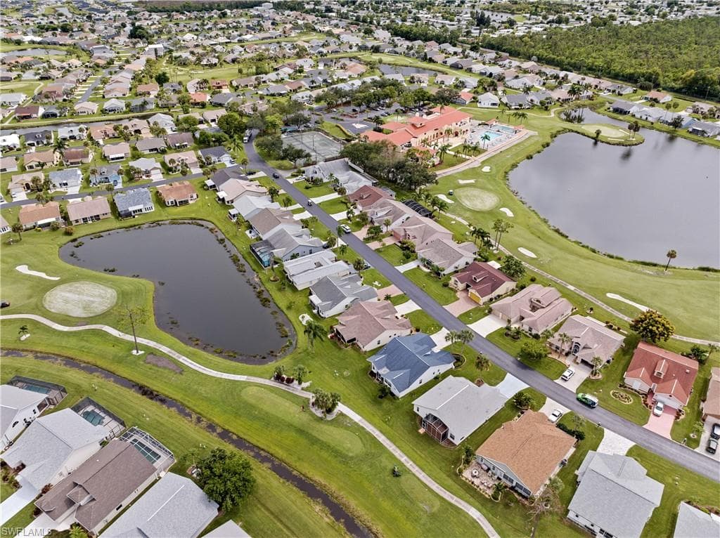 Home (blue roof) showing back pond and golf course view. Note the red roof of the clubhouse - a short distance away.