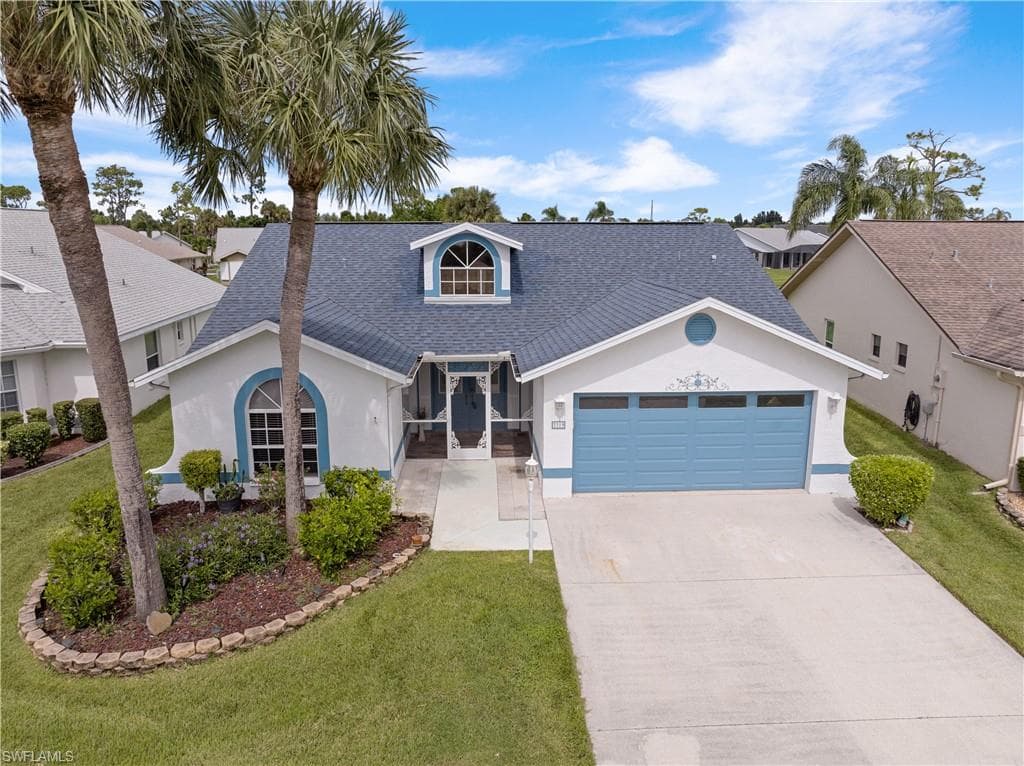 Elevated view of front of home and two car garage.
