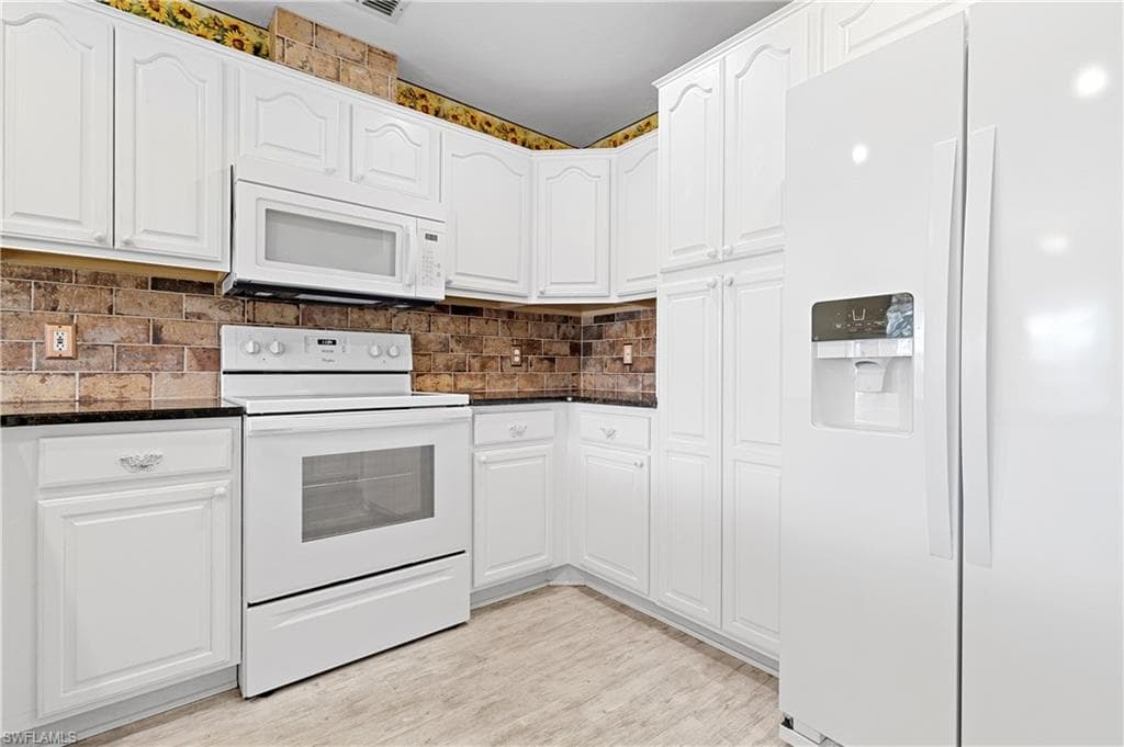 Granite Counters and beautiful white wood cabinates.
