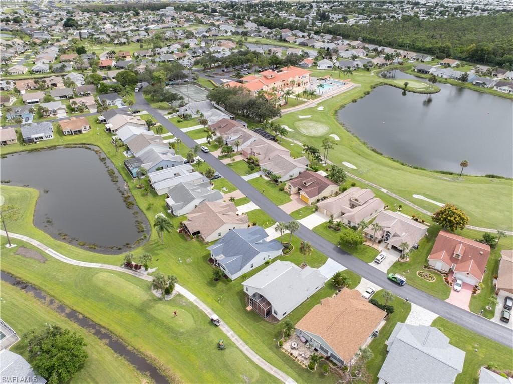 Another look at home, (blue roof) showing back pond and golf course view. Note the red roof of the clubhouse - a short distance away. Yes, it's walkable!