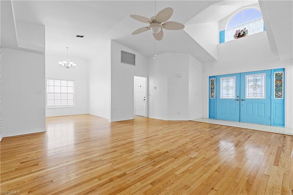 Looking from front great/family room at entry double doors. Door to garage off to left by the laundry room.