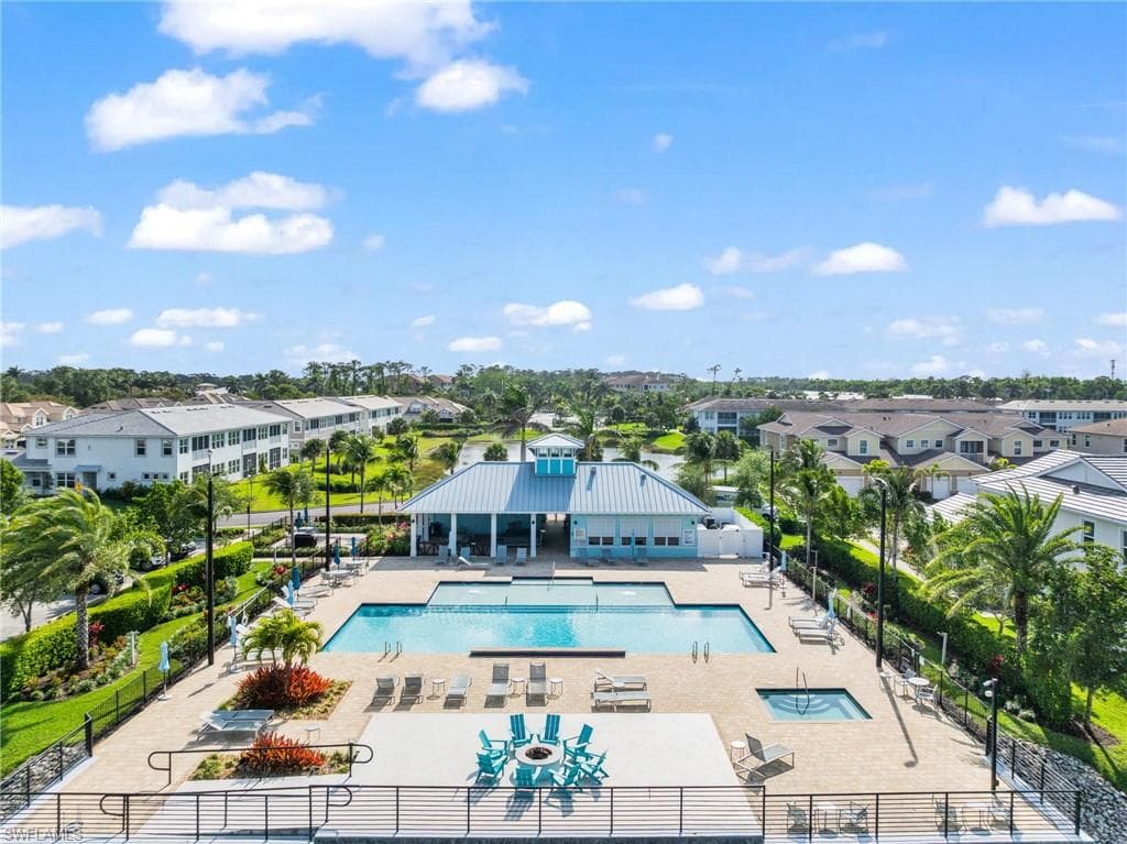 Community pool featuring a patio area and a residential view