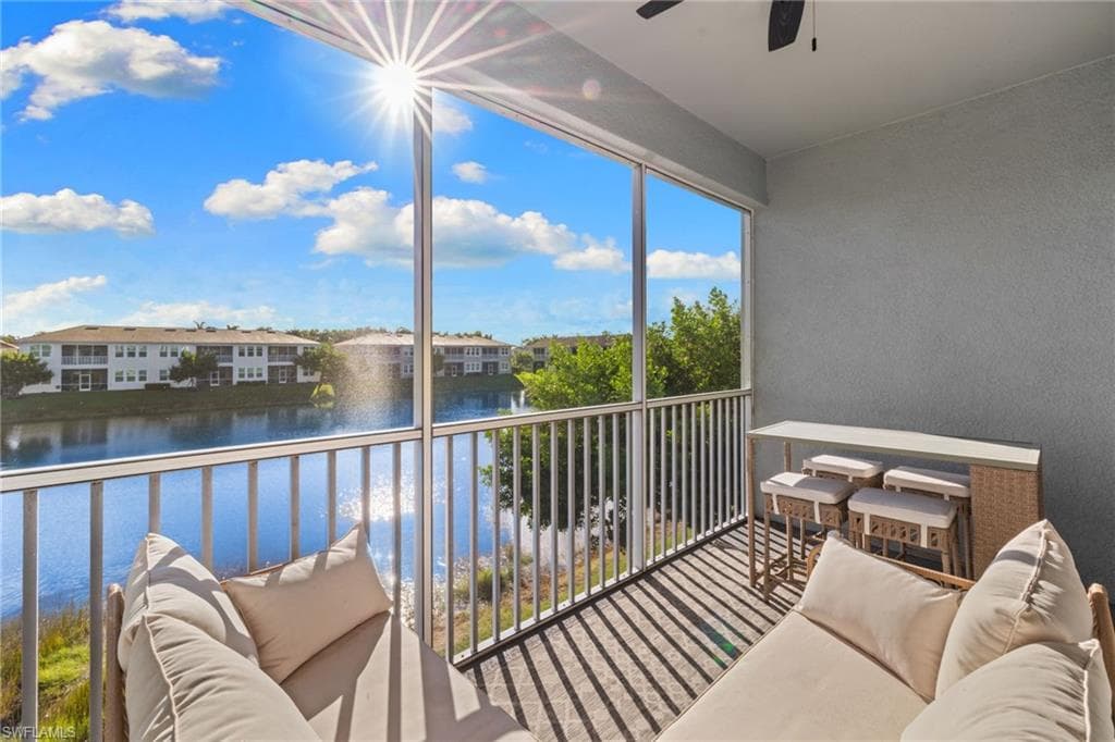 Balcony with an outdoor hangout area, a water view, and ceiling fan