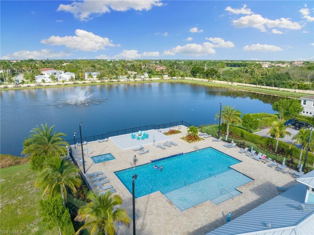 Bird's eye view of a pool area and a nearby body of water
