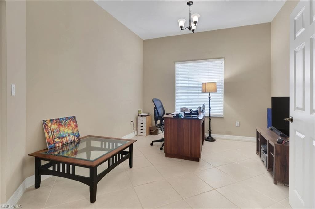 Office area with light tile patterned floors and a chandelier