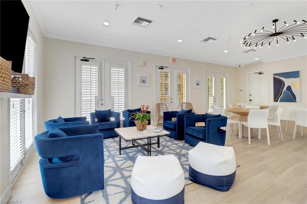 Living area featuring light wood finished floors, ornamental molding, french doors, and recessed lighting