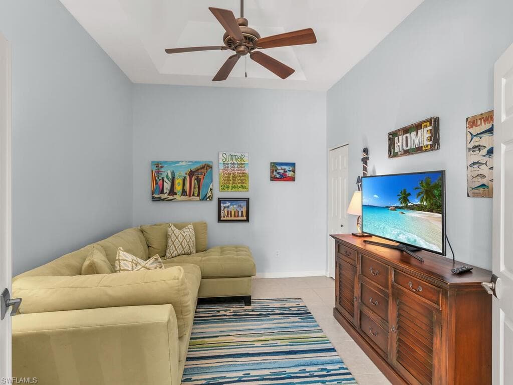 Living area with tile patterned flooring and a ceiling fan