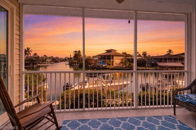 Balcony with a water view and a sunroom
