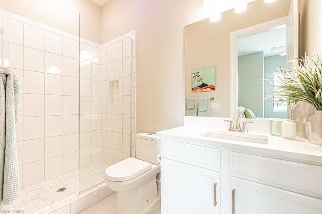 Bathroom featuring a shower stall and vanity