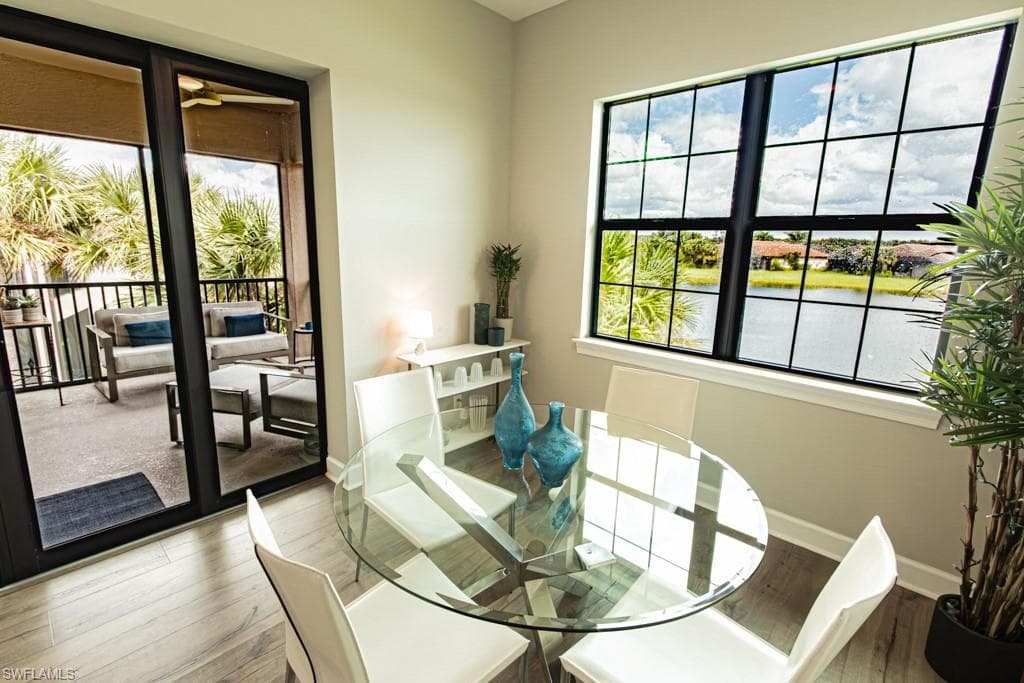 Dining space with healthy amount of natural light and wood finished floors