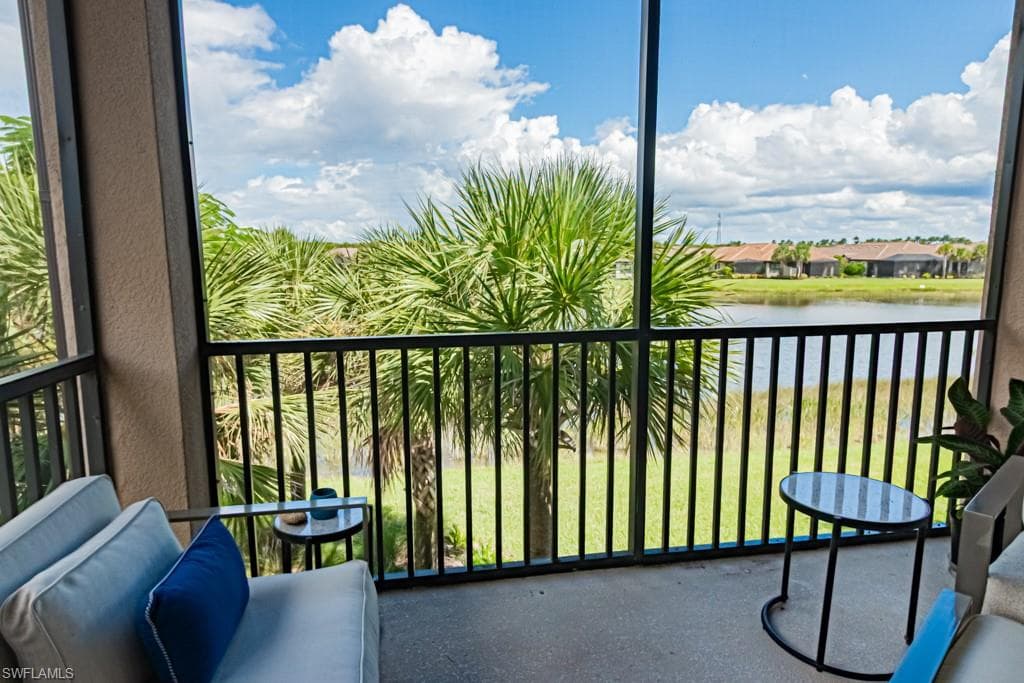 Balcony with a sunroom and a water view
