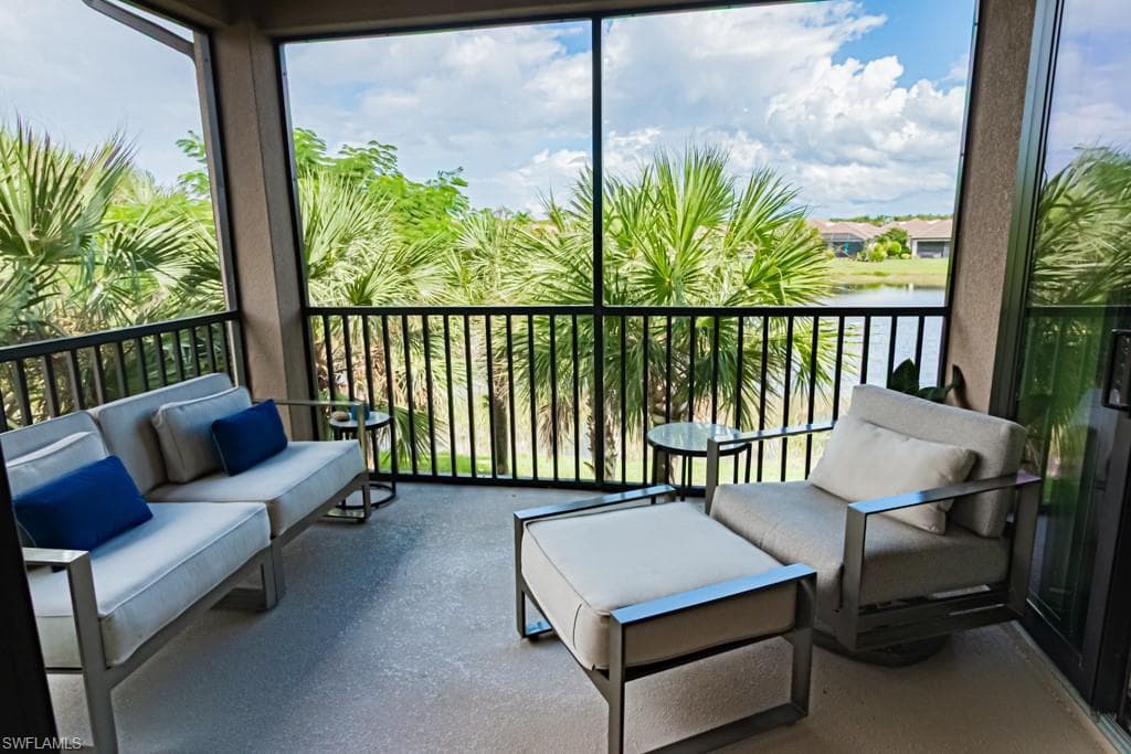 Sunroom featuring a water view