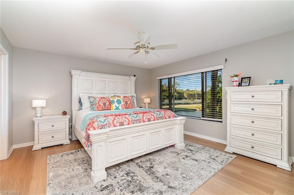 Bedroom with king bed and electric shutter on window