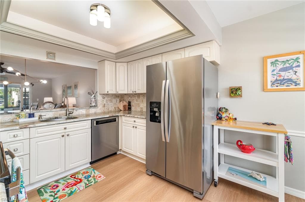 Kitchen with tray ceiling and beautiful lighting