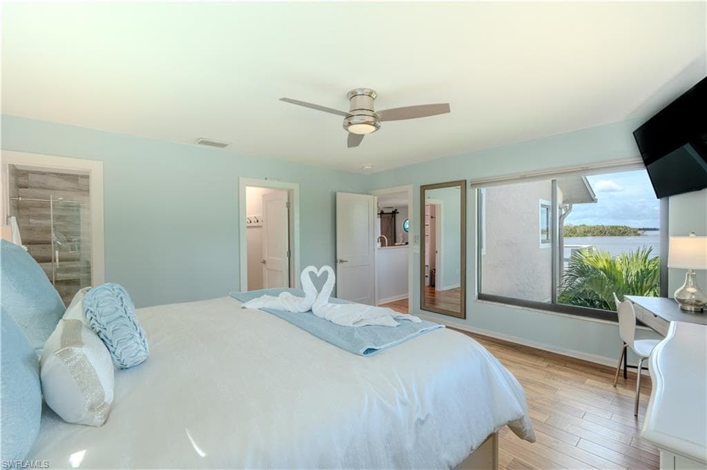 Bedroom featuring wood finished floors and a ceiling fan - Virtually Edited Image