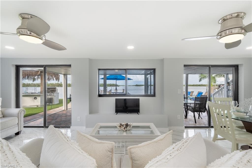Living room featuring ceiling fan and recessed lighting - Virtually Edited Image