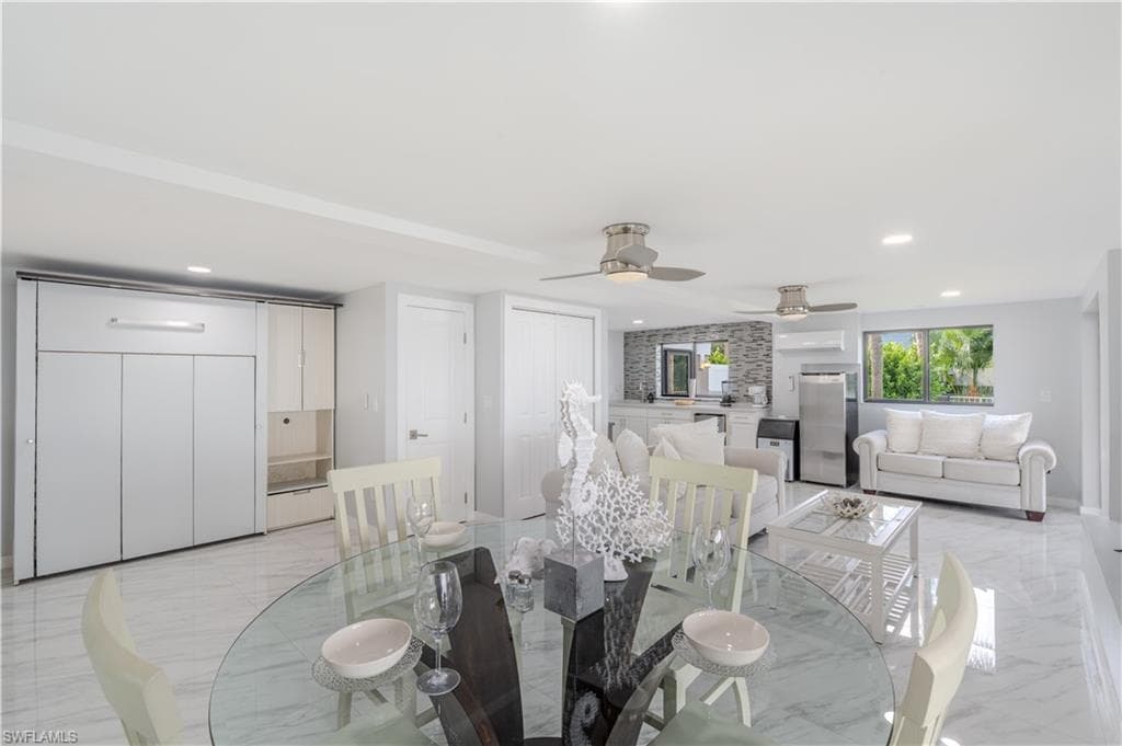 Dining room featuring light tile finish flooring, recessed lighting, and a ceiling fan - Virtually Edited Image