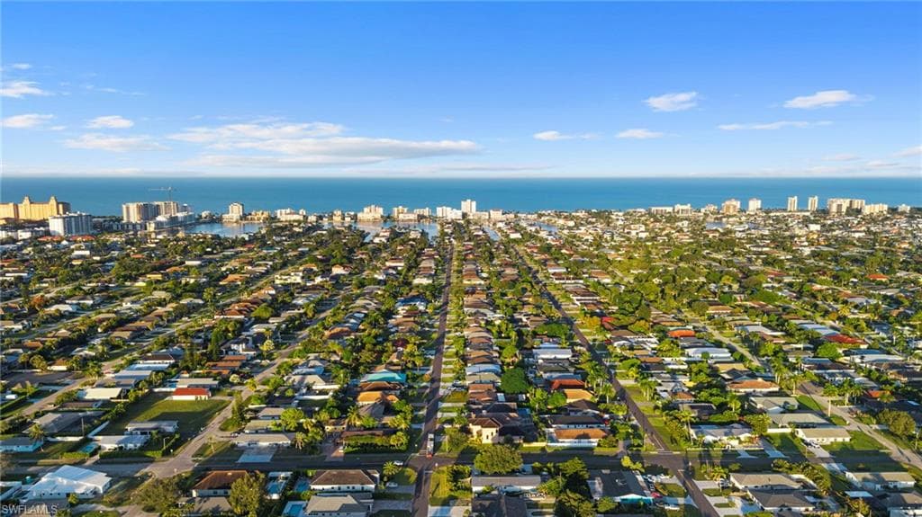 Aerial view of property's location with a large body of water