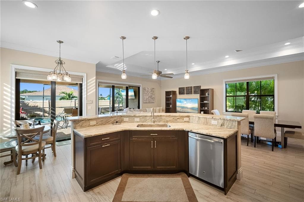 Kitchen featuring dark brown cabinetry, recessed lighting, hanging light fixtures, dishwasher, and ceiling fan