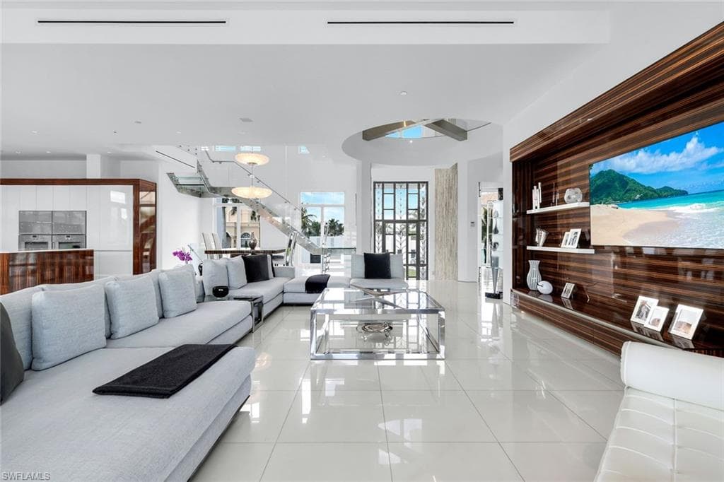 Stylish living area by TV with Allmilmo cabinetry, Macassar wood accents