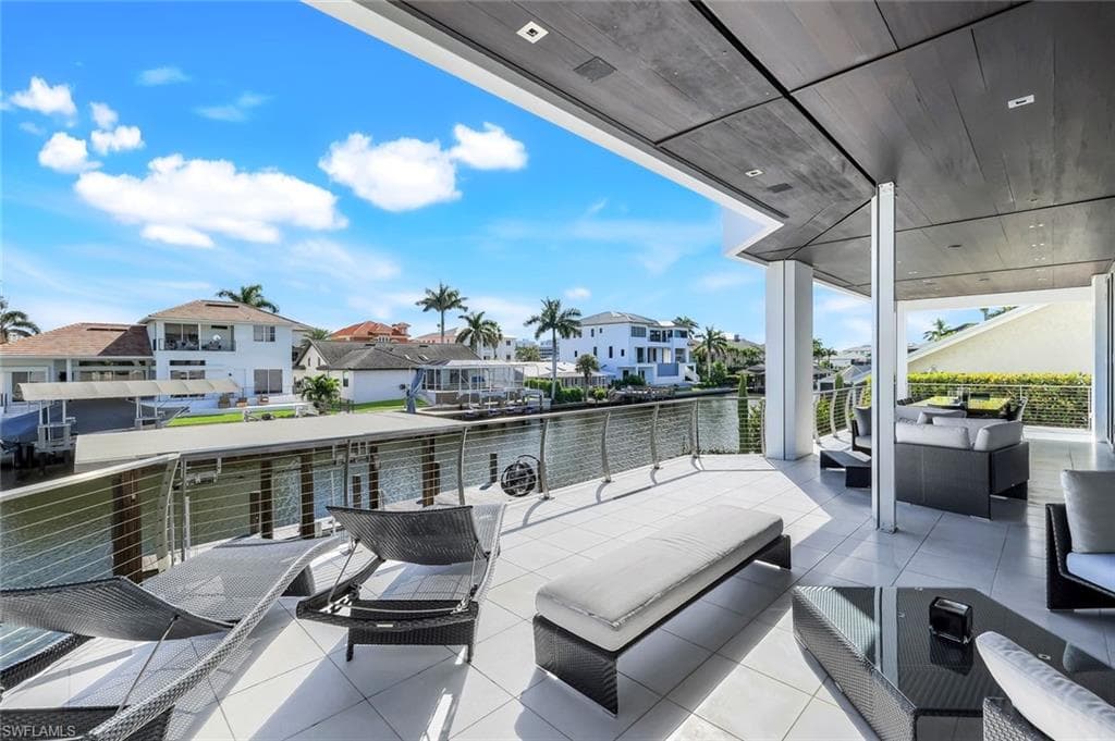View of patio / terrace with an outdoor hangout area, a water view, and a residential view