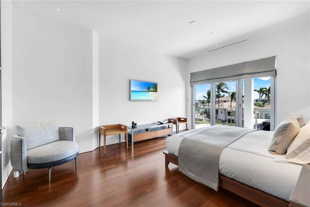 Bedroom with access to outside and walnut floors