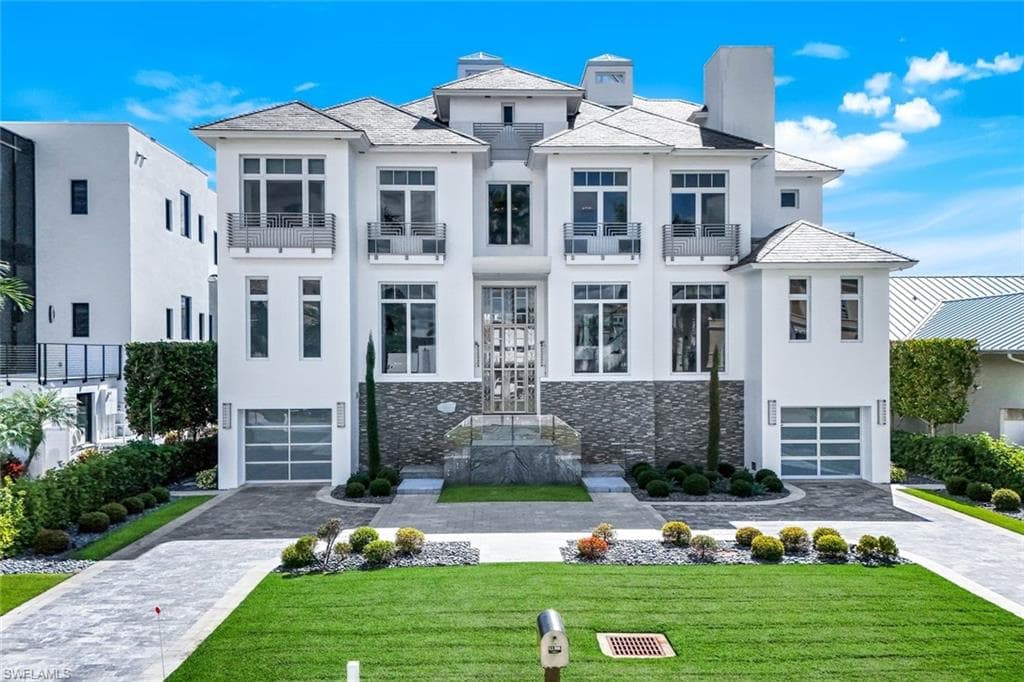 Granite driveway, Thassos marble decks, stainless railings by Zynda Custom Homes.