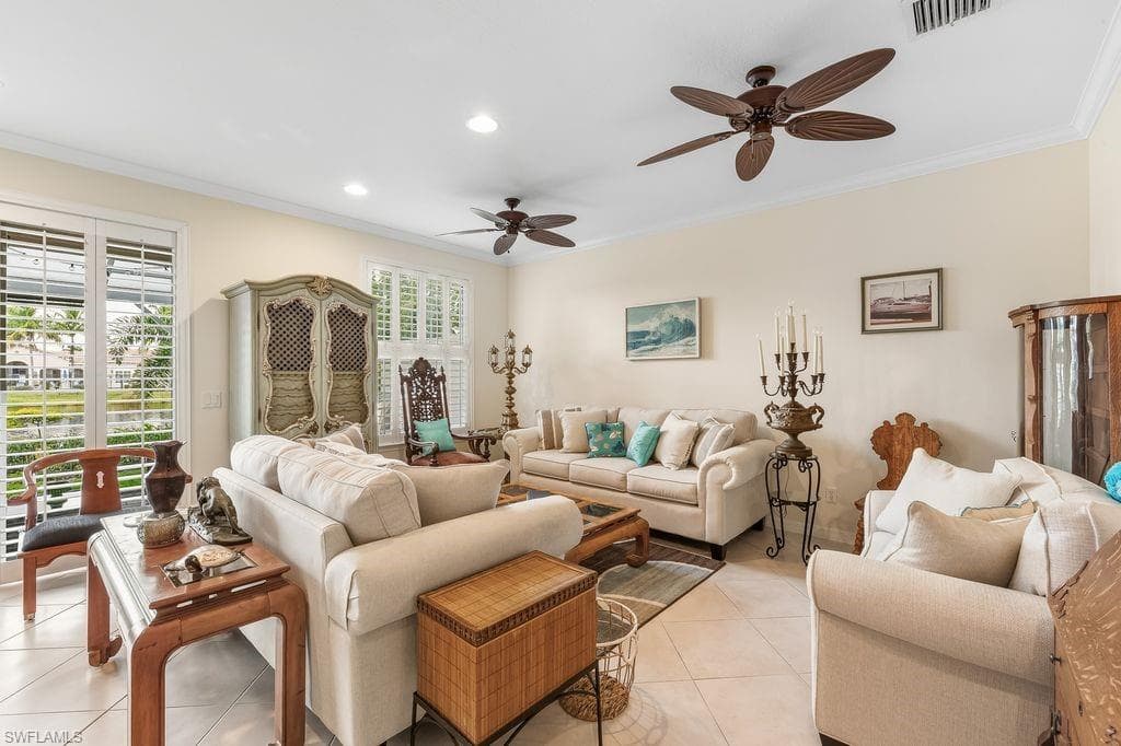 Living room with crown molding, light tile patterned flooring, plenty of natural light, a ceiling fan, and recessed lighting