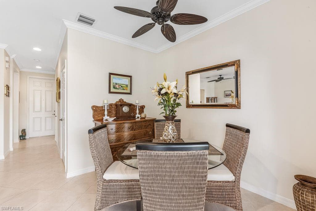 Dining area with light tile patterned floors, ornamental molding, a ceiling fan, and recessed lighting