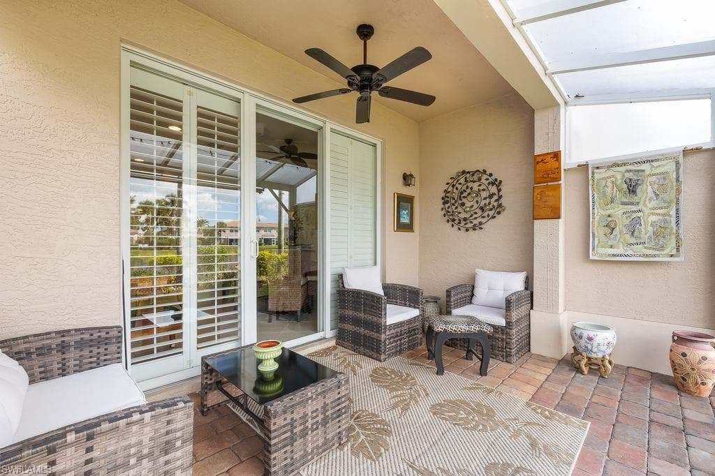 View of extended screened lanai with paver tiles and a ceiling fan