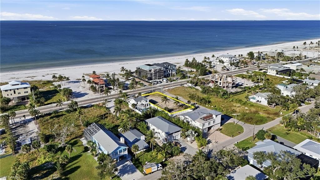 Aerial overview of property's location featuring expansive beach - Virtually Edited Image